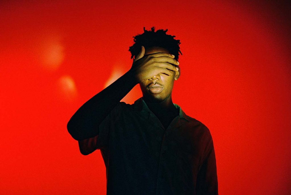 image of a black man shielding his eyes