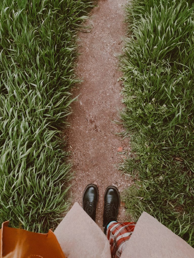 image of feet starting to walk on a path outside in nature